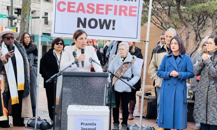 The photo: Councilmember Teresa Mosqueda giving a passionate speech during a rally for peace on November 15 in downtown Seattle. Also, State Senator Yasmin Trudeau and Council Member Tammy Morales can be seen in the photo far right hands folded.